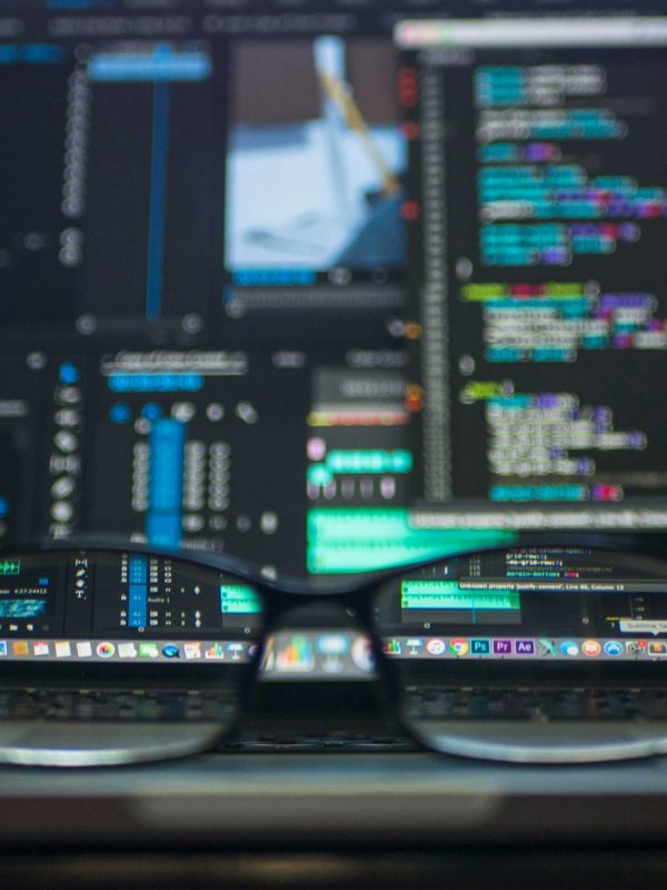pexels-photo-577585-577585 Eyeglasses reflecting computer code on a monitor, ideal for technology and programming themes.